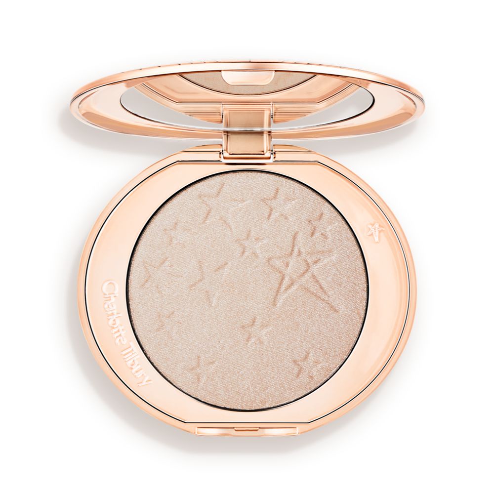 An open highlighter powder compact with a mirrored lid, in a shimmery silvery-opal shade.