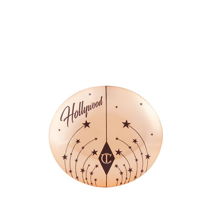 A closed highlighter compact with a gold-coloured lid, with tiny stars printed all over and Hollywood written on the top.