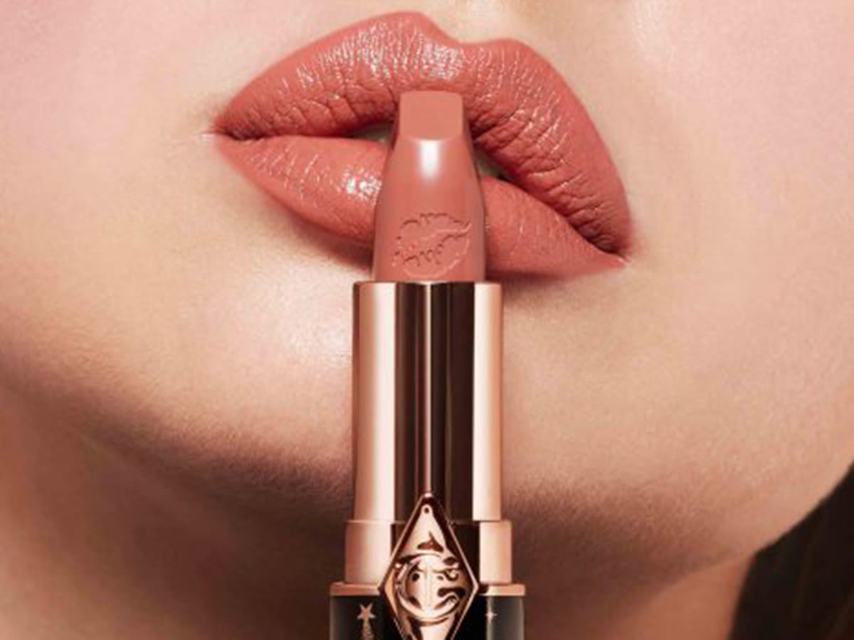 Lips close-up of a light-tone model wearing a nude-pink, universally-flattering lipstick.