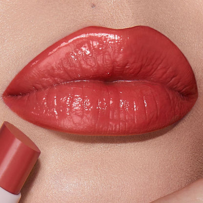 Lips close-up of a light-tone model wearing a moisturising lipstick balm in a peach rose shade.
