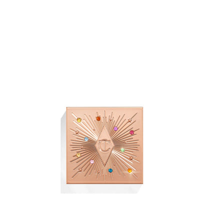 A closed, one-pan eyeshadow compact in light golden colour with colourful stones all over the lid.
