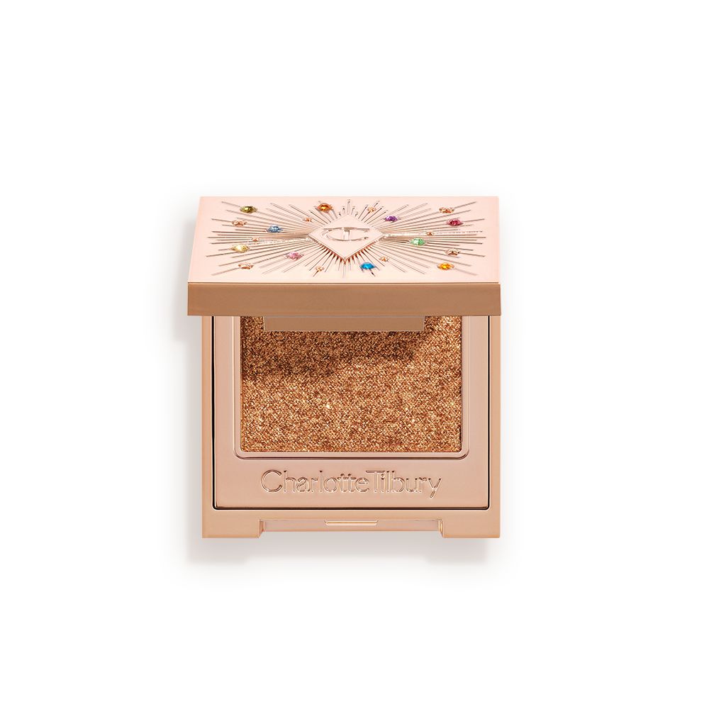 An open, single-pan eyeshadow with a mirrored lid in an iridescent orange-gold shade with very fine shimmer.