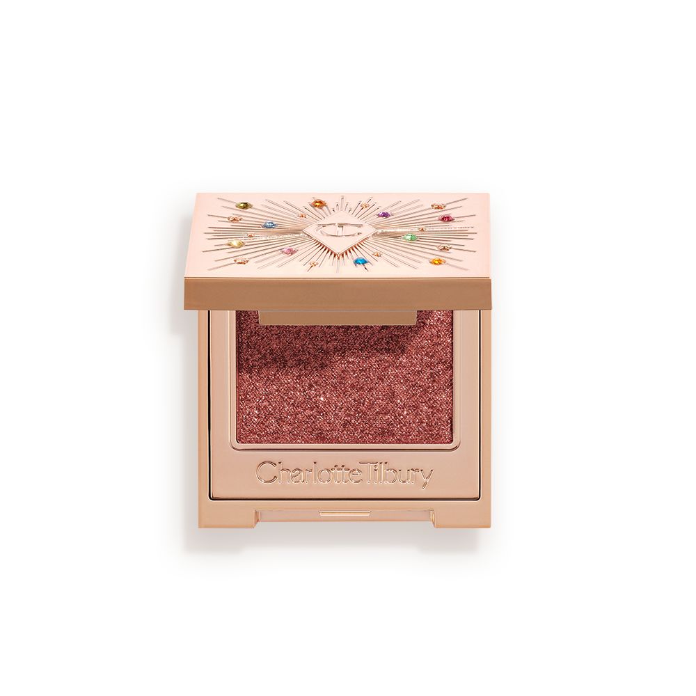 An open, single-pan eyeshadow with a mirrored lid in an iridescent rustic red shade with very fine shimmer.