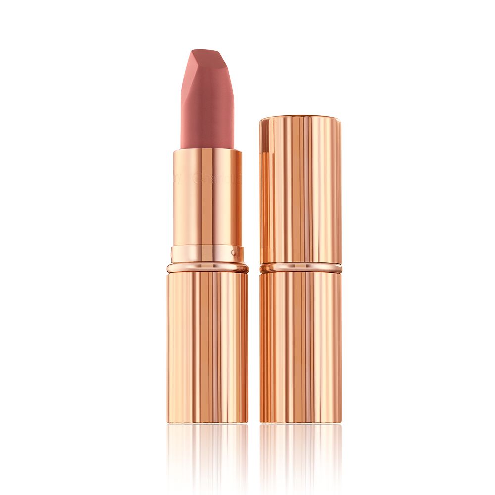 Two lipsticks, with and without lid, in a mid-toned muted nude-rose matte shade, in sleek, gold-coloured tubes.