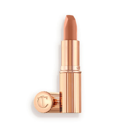 Two lipsticks, with and without lid, in a fresh, neutral nude peach matte shade, in sleek, gold-coloured tubes.