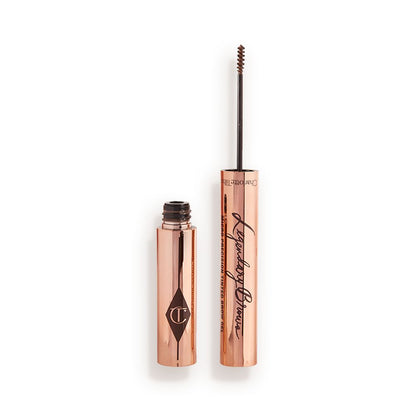 Open, tinted brow gel in a soft brown shade with a thin brush for precision, and a shiny, gold-coloured tube.