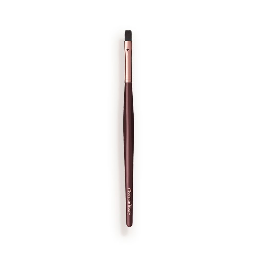 A slim lip brush in dark crimson and gold colour scheme.
