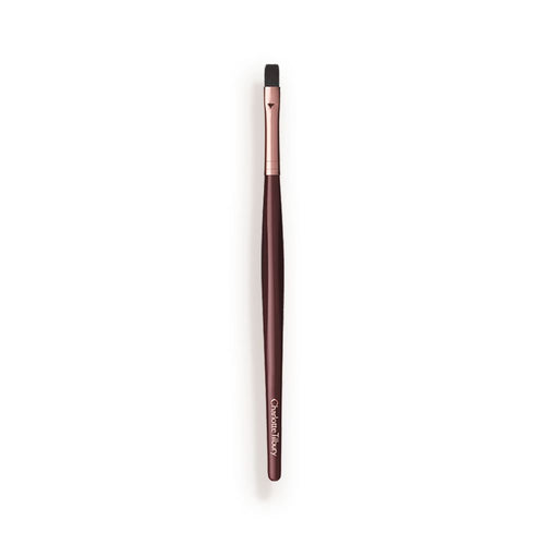 A slim lip brush in dark crimson and gold colour scheme.