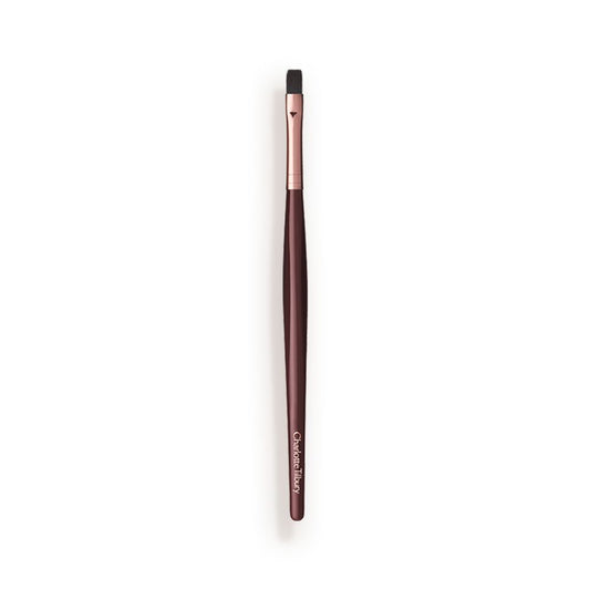 A slim lip brush in dark crimson and gold colour scheme.