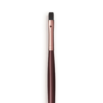Close-up of a lip brush with a rose-gold and dark crimson handle.