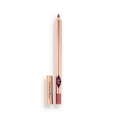 A standard-sized, nude-pink lip liner pencil with its lid removed, with a reflective, golden-coloured exterior.