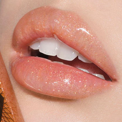Lips close-up of a fair-tone model wearing sheer gold lip gloss with a high-shine finish.