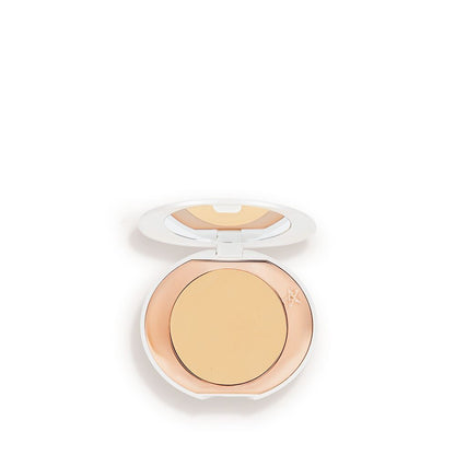 A miniature compact brightening powder in a white shade for tan and deep skin tones.
