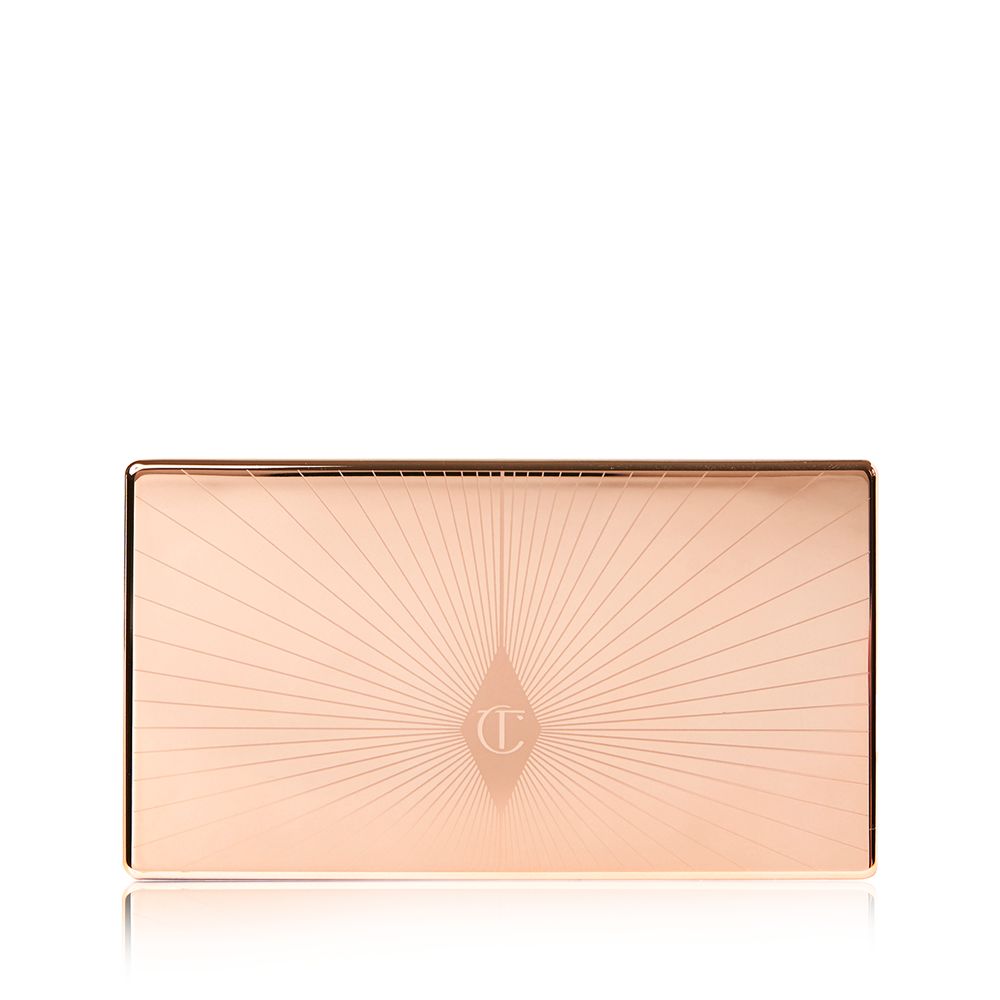 A closed duo contour palette with a light gold-coloured lid with a starburst pattern on top in a darker shade of gold.
