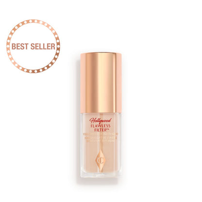 A closed glow-boosting primer in a glass bottle with a rose gold-coloured lid.