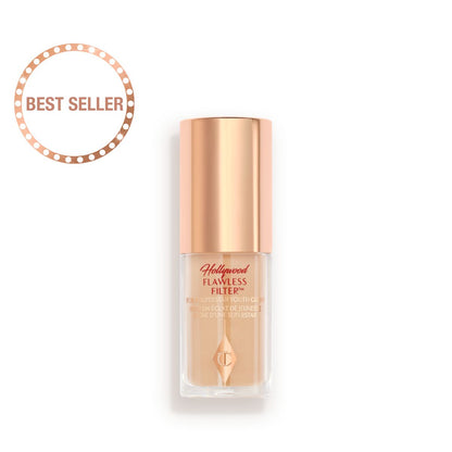 A closed glow-boosting primer in a glass bottle with a rose gold-coloured lid.