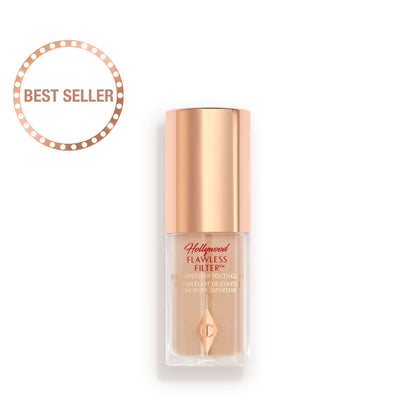 A closed glow-boosting primer in a glass bottle with a rose gold-coloured lid.