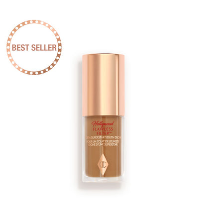 A mini luminous primer in a medium-dark shade in a glass bottle with a gold-coloured lid.