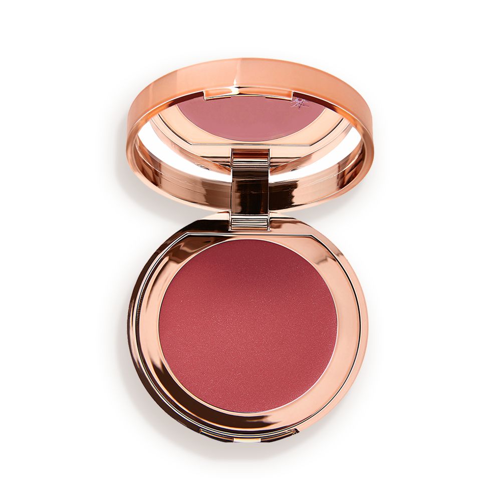 An open, mirrored-lid lip and cheek cream compact in a warm rosebud-pink shade.