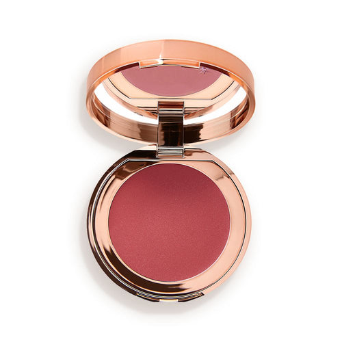 An open, mirrored-lid lip and cheek cream compact in a warm rosebud-pink shade.