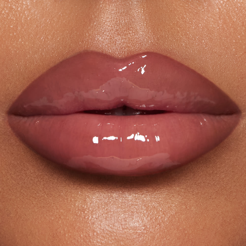 Close up of model wearing Pillow Talk Big Lip Plumpgasm lip gloss