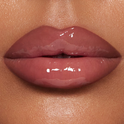 Close up of model wearing Pillow Talk Big Lip Plumpgasm lip gloss