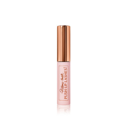 A travel-size mascara in a pink-coloured tube with a gold-coloured lid.
