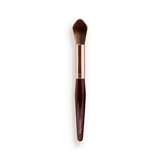 A powder brush with soft bristles and the handle in a dark crimson and rose-gold colour scheme.