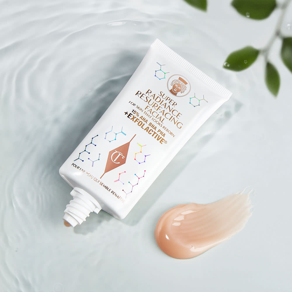 An exfoliating, wash-off, chemical mask in a white-coloured tube with gold-coloured text on it and its brown-champagne-coloured creamy swatch next to it.