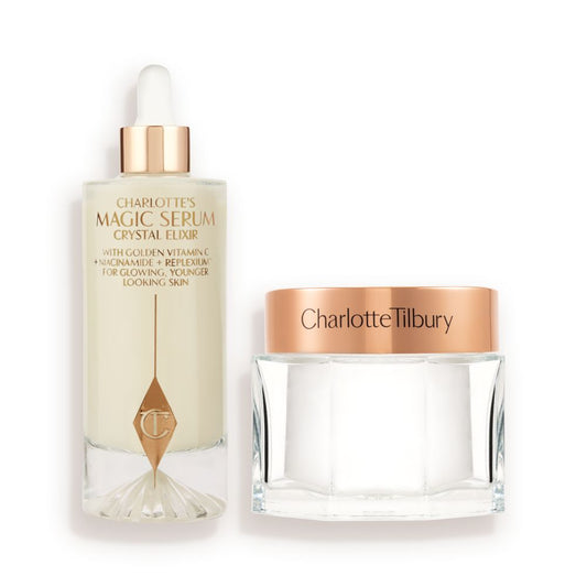 A large serum in a glass bottle with a golden and white-coloured dropper lid and pearly-white face cream in a glass jar with a rose-gold-coloured lid.