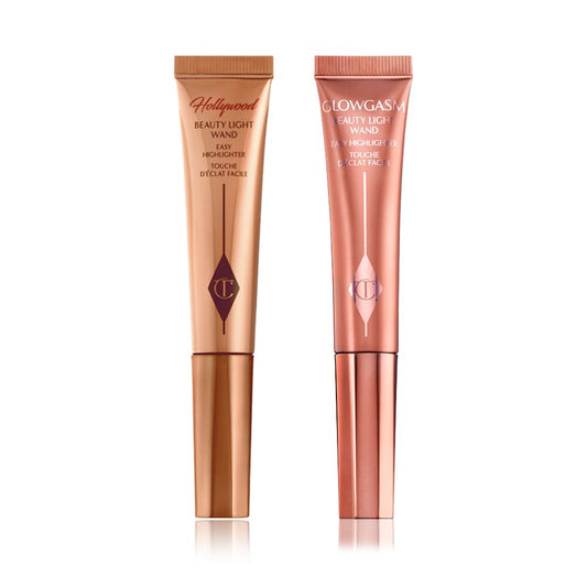 A highlighter wand and a highlighter blush wand with reflective packaging in rose gold and honey-gold shades.
