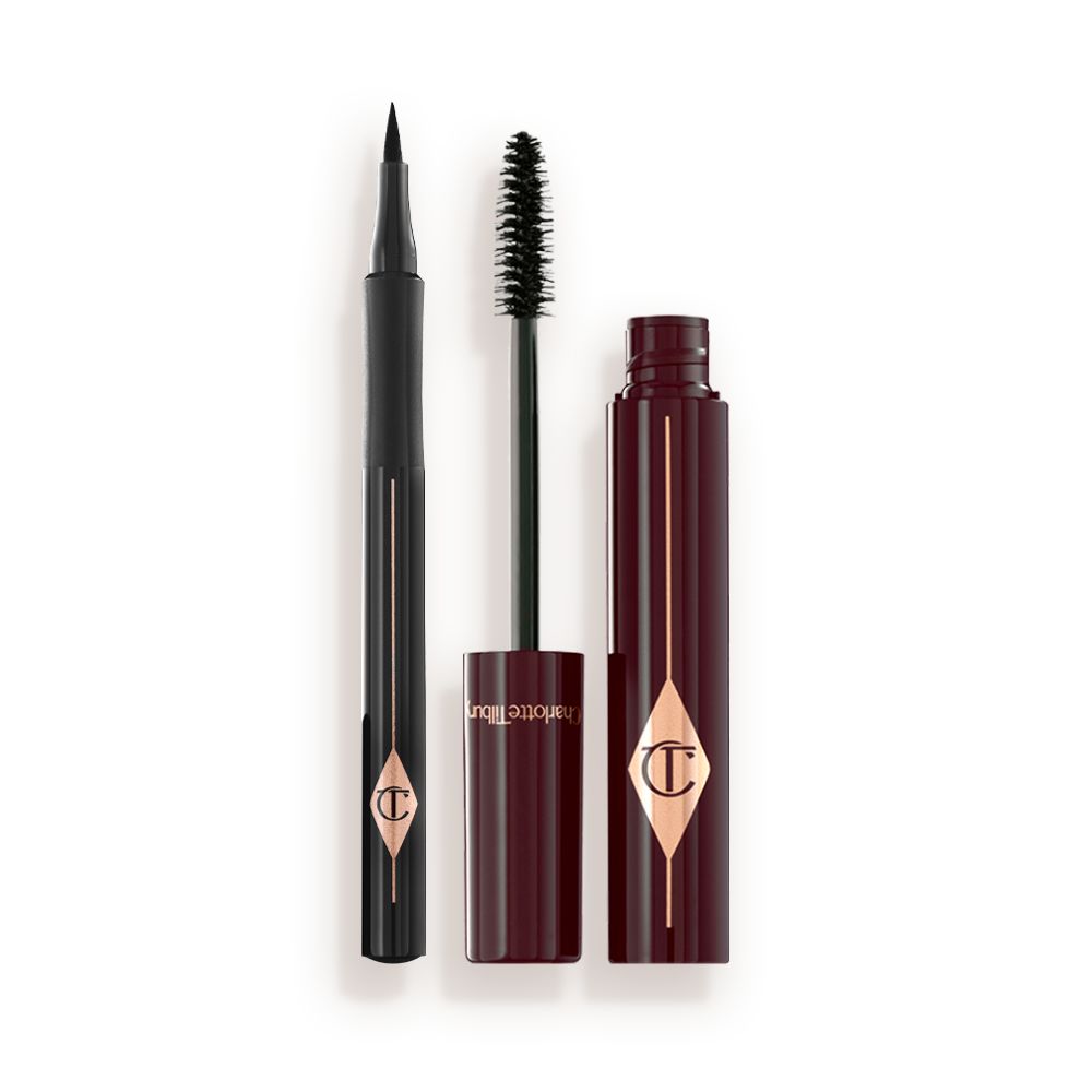 An open mascara with its applicator next to it in dark crimson-cloured packaging and an open eyeliner pen in black colour.