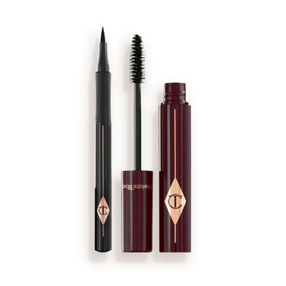 An open mascara with its applicator next to it in dark crimson-cloured packaging and an open eyeliner pen in black colour.
